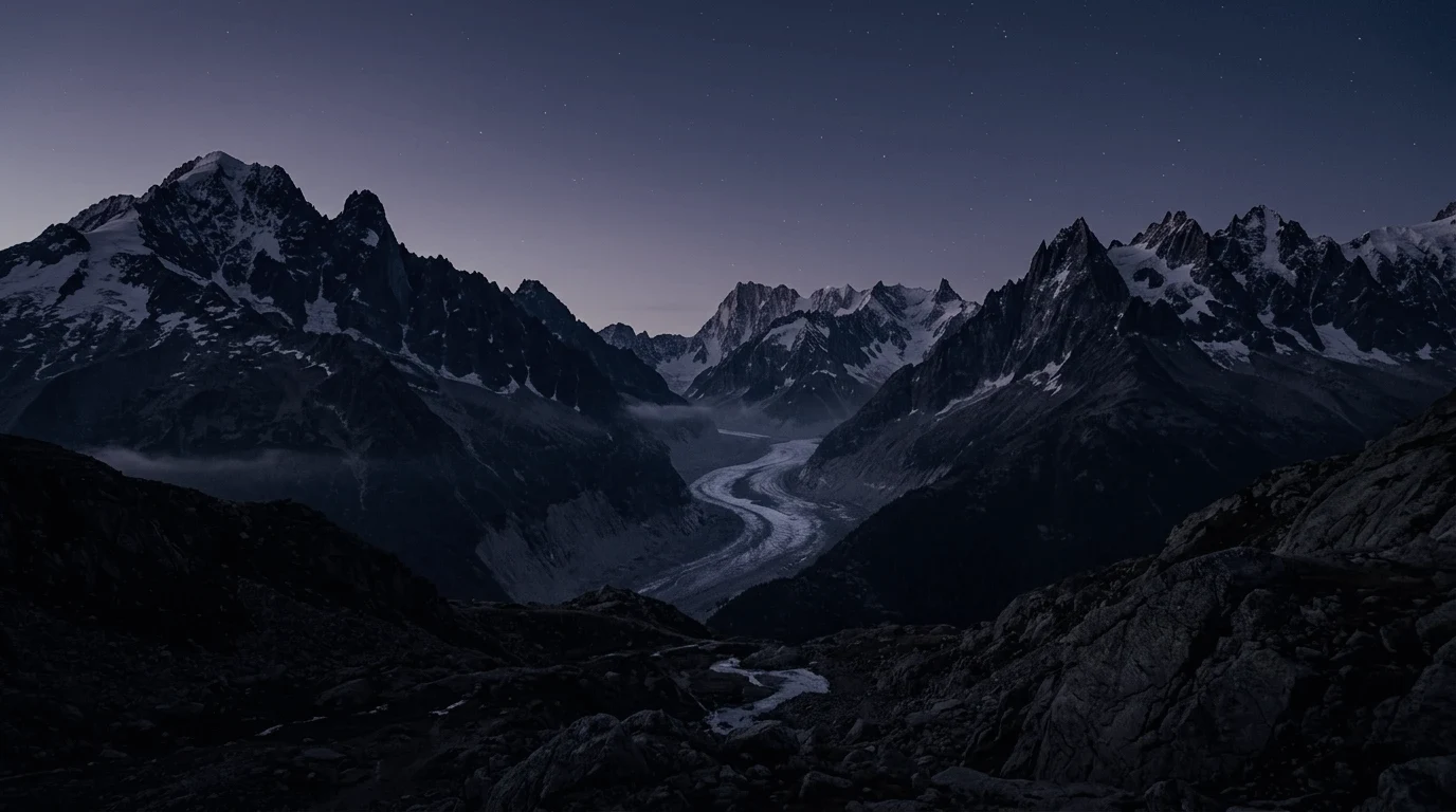 Moonlit alpine peaks beneath a quiet, star-filled sky